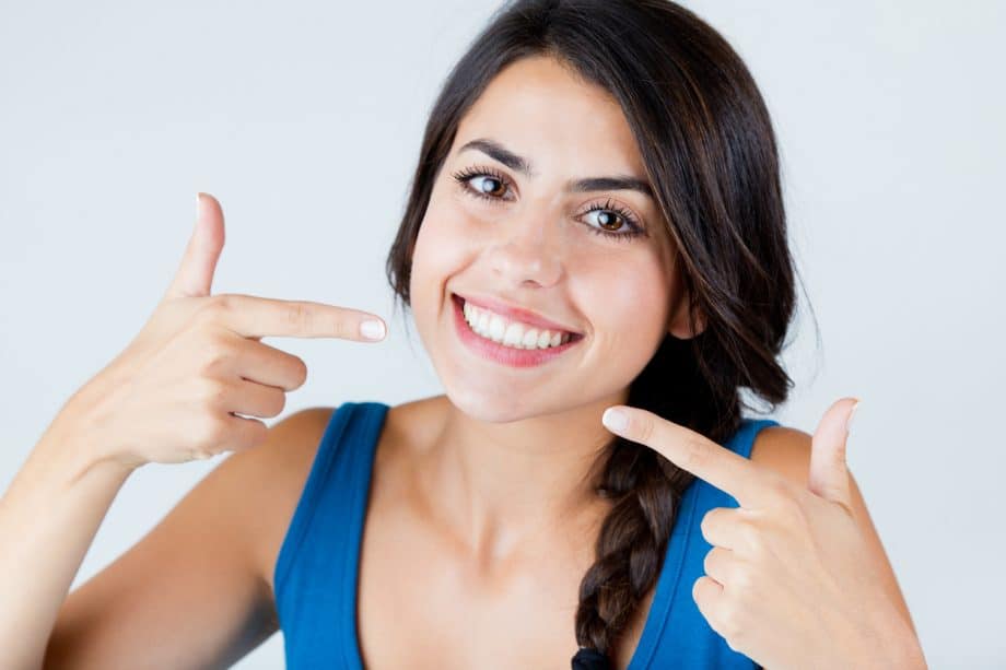 Confident Girl Pointing At Her Smile