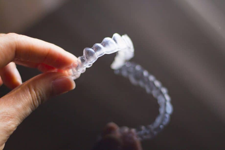 person holding invisalign retainer